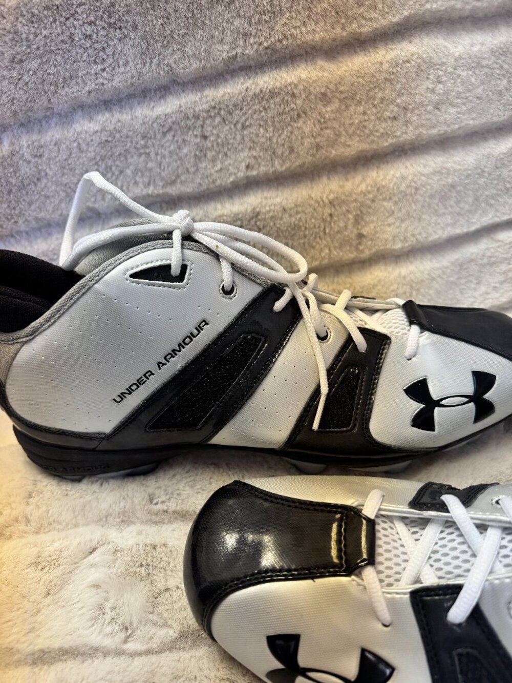 White and black Under Armour Demolition Mid football cleats